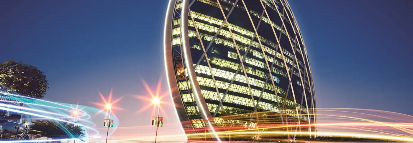 Aldar's headquarters building in Abu Dhabi at dusk.